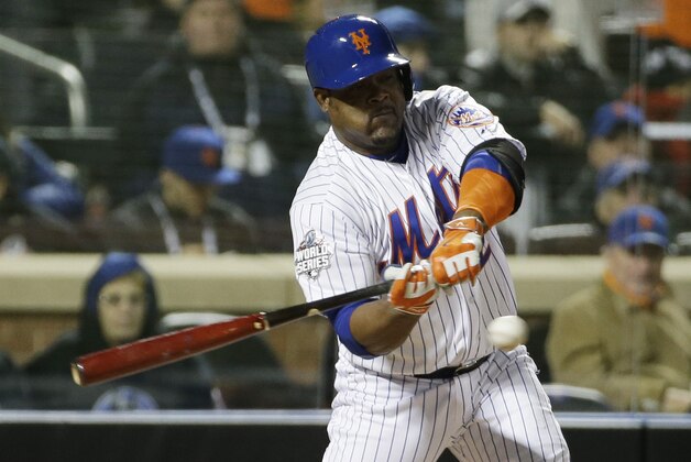New York Mets' Juan Uribe hits an RBI single during the sixth inning of Game 3 of the Major League Baseball World Series against the Kansas City Royals Friday, Oct. 30, 2015, in New York. (AP Photo/David J. Phillip)