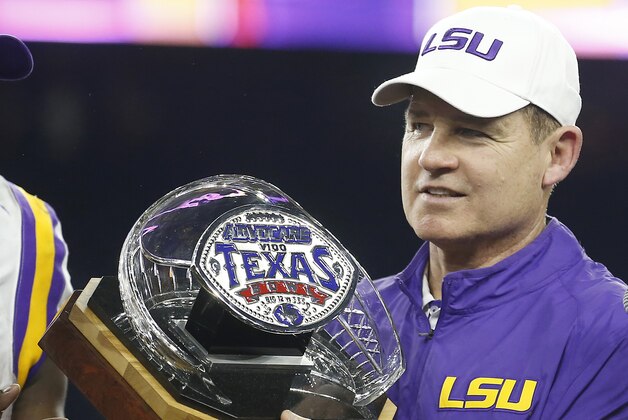 Dec 29, 2015; Houston, TX, USA; LSU Tigers head coach Les Miles holds the Texas Bowl trophy after defeating the Texas Tech Red Raiders 56-27 at NRG Stadium. LSU won 56 to 27. Mandatory Credit: Thomas B. Shea-USA TODAY Sports
