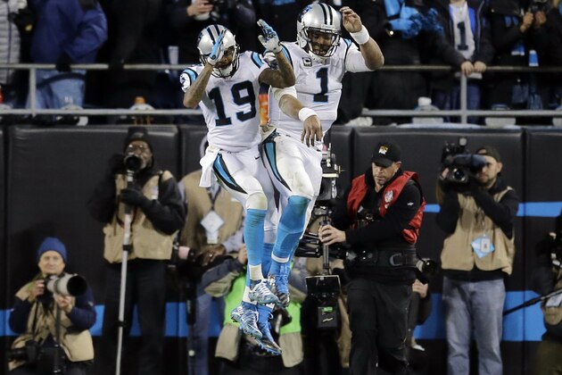 Carolina Panthers' Cam Newton celebrates his touchdown run with Ted Ginn (19) during the second half the NFL football NFC Championship game against the Arizona Cardinals Sunday, Jan. 24, 2016, in Charlotte, N.C. (AP Photo/David J. Phillip)