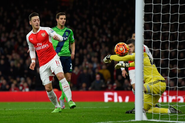 LONDON, ENGLAND - FEBRUARY 02: Fraser Forster of Southampton makes a save a shot by Mesut Ozil of Arsenal during the Barclays Premier League match between Arsenal and Southampton at the Emirates Stadium on February 2, 2016 in London, England.  (Photo by Mike Hewitt/Getty Images)