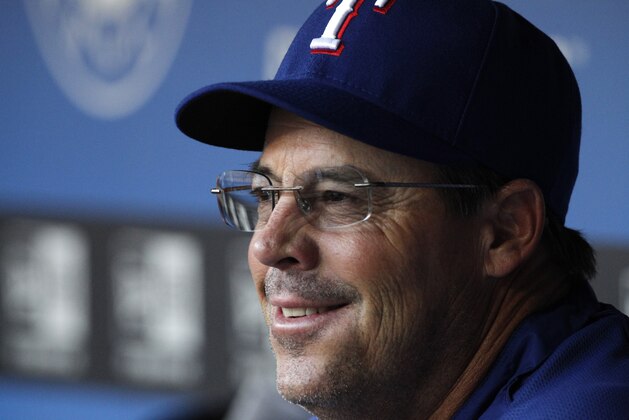 Texas Rangers special assistant coach Greg Maddux sits in the dugout before a baseball game against the Cleveland Indians Wednesday, Sept. 12, 2012, in Arlington, Texas. The Rangers won 5-2. (AP Photo/Tony Gutierrez)