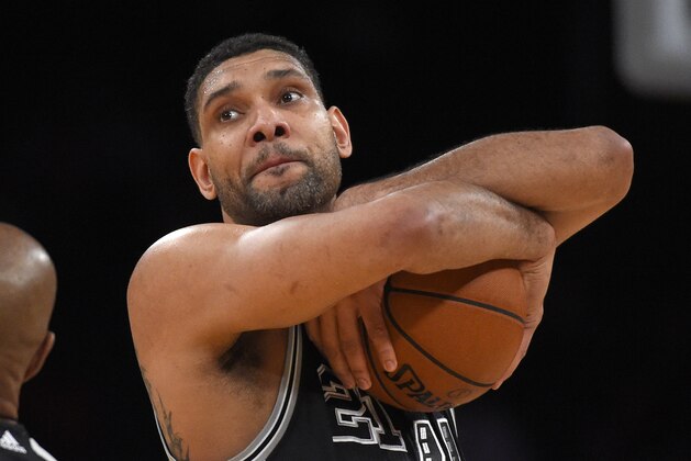 San Antonio Spurs center Tim Duncan hugs the ball prior to the Spurs' NBA basketball game against the Los Angeles Lakers, Friday, Jan. 22, 2016, in Los Angeles. (AP Photo/Mark J. Terrill)