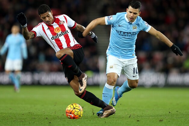 Sunderland's Patrick Van Aanholt, left, vies with Manchester City's Sergio Aguero, right, during the English Premier League soccer match between Sunderland and Manchester City at the Stadium of Light, Sunderland, England, Tuesday, Feb. 2, 2016. (AP Photo/Scott Heppell)