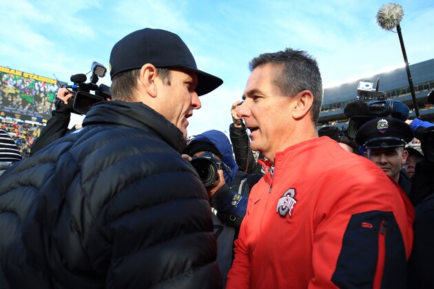 ANN ARBOR, MI - NOVEMBER 28: Head coach Urban Meyer of the Ohio State Buckeyes and head coach Jim Harbaugh of the Michigan Wolverines after the game against the Michigan Wolverines at Michigan Stadium on November 28, 2015 in Ann Arbor, Michigan. Ohio State defeated Michigan 42-13. (Photo by Andrew Weber/Getty Images)
