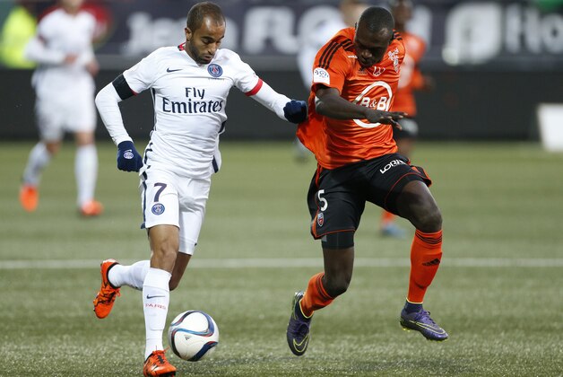 LORIENT, FRANCE - NOVEMBER 21: Lucas Moura of PSG and Zargo Toure of FC Lorient in action during the French Ligue 1 match between FC Lorient and Paris Saint-Germain (PSG) at Stade du Moustoir on November 21, 2015 in Lorient, France. (Photo by Jean Catuffe/Getty Images)