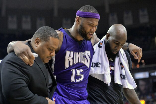 Sacramento Kings center DeMarcus Cousins (15) is helped off the court in the second half of an NBA basketball game against the Memphis Grizzlies, Saturday, Jan. 30, 2016, in Memphis, Tenn. (AP Photo/Brandon Dill)