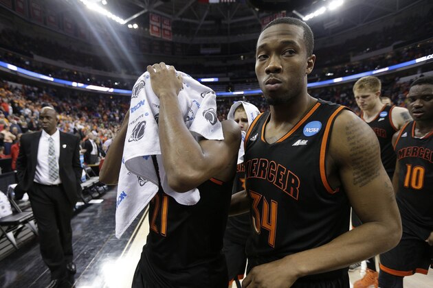 Mercer's Langston Hall and Jibri Bryan (34) walks off the court after the second half of an NCAA college basketball third-round tournament game against Tennessee , Sunday, March 23, 2014, in Raleigh. Tennessee Won 83-63. (AP Photo/Chuck Burton)