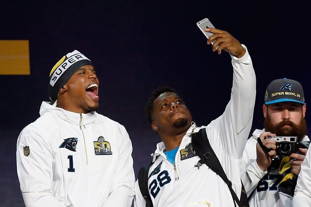 SAN JOSE, CA - FEBRUARY 01:  Cam Newton #1 of the Carolina Panthers and Jonathan Stewart #28 take a picture together as they are introduced at Super Bowl Opening Night Fueled by Gatorade at SAP Center on February 1, 2016 in San Jose, California.  (Photo by Ezra Shaw/Getty Images)