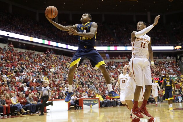 West Virginia guard Daxter Miles Jr. drives to the basket past Iowa State guard Monte Morris (11) during the first half of an NCAA college basketball game Tuesday, Feb. 2, 2016, in Ames, Iowa. (AP Photo/Charlie Neibergall)