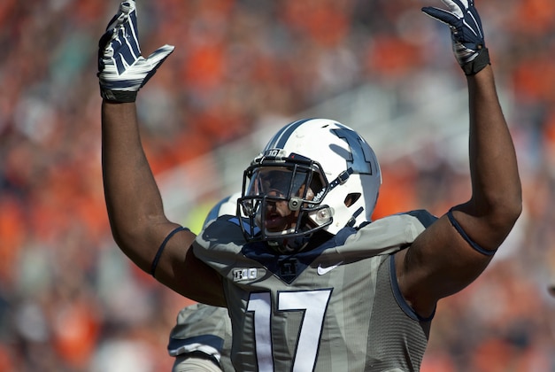 FILE - In this Oct. 25, 2014, file photo, Illinois defensive end Jihad Ward encourages the crowd during an NCAA football game against Minnesota in Champaign, Ill. Ward, the teams best returning player, will miss the first two games this season after he suffered a knee injury that required surgery. Illinois hosts Kent State in their season opener on Sept. 4, 2015. (AP Photo/Bradley Leeb, File)