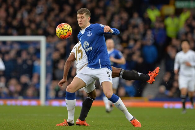 Swansea City's English midfielder Wayne Routledge (L) vies with Everton's English defender John Stones during the English Premier League football match between Everton and Swansea City at Goodison Park in Liverpool, north west England on January 24, 2016. AFP PHOTO / PAUL ELLIS

RESTRICTED TO EDITORIAL USE. No use with unauthorized audio, video, data, fixture lists, club/league logos or 'live' services. Online in-match use limited to 75 images, no video emulation. No use in betting, games or single club/league/player publications. / AFP / PAUL ELLIS        (Photo credit should read PAUL ELLIS/AFP/Getty Images)