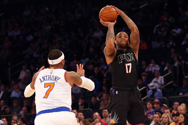 Jan 29, 2016; New York, NY, USA;  Phoenix Suns forward P.J. Tucker (17) shoots over New York Knicks forward Carmelo Anthony (7) during the first quarter at Madison Square Garden. Mandatory Credit: Anthony Gruppuso-USA TODAY Sports