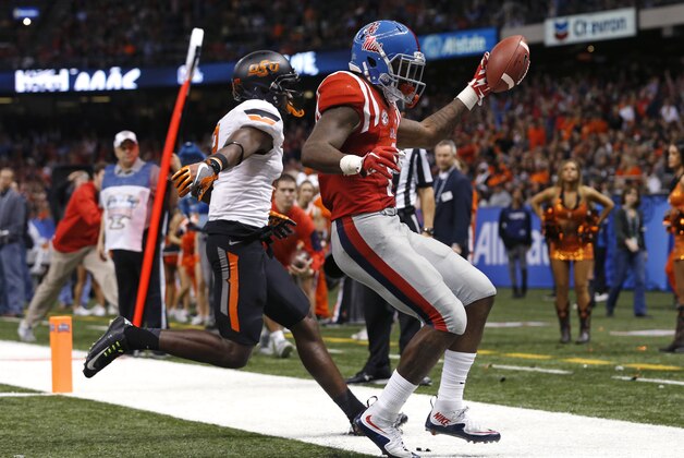 Mississippi wide receiver Laquon Treadwell (1) scores a touchdown as Oklahoma State cornerback Darius Curry covers in the second half of the Sugar Bowl college football game in New Orleans, Friday, Jan. 1, 2016. (AP Photo/Jonathan Bachman)