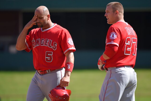 ARLINGTON, TX - OCTOBER 3: Albert Pujols #5 and Mike Trout #27 of the Los Angeles Angels of Anaheim reacts after being stranded during the seventh inning of the game against the Texas Rangers at Globe Life Park in Arlington on October 3, 2015 in Arlington, California. (Photo by Matt Brown/Angels Baseball LP/Getty Images)