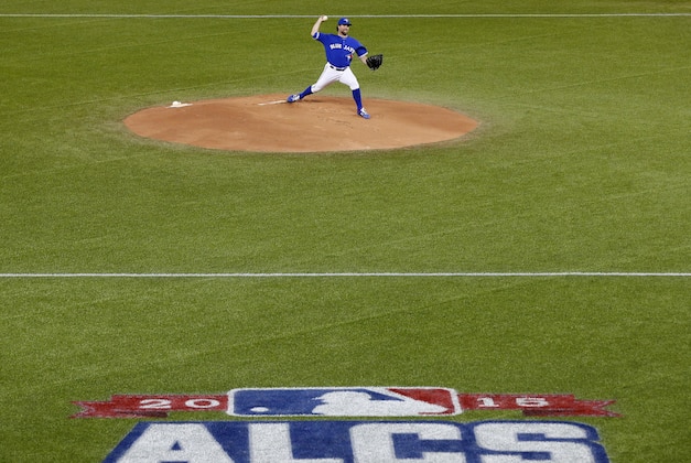 Toronto Blue Jays starting pitcher R.A. Dickey throws against the Kansas City Royals during the first inning in Game 4 of baseball's American League Championship Series on Tuesday, Oct. 20, 2015, in Toronto. (AP Photo/Paul Sancya)