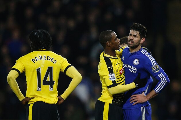 Watford's Nigerian striker Odion Ighalo (C) stands between Chelsea's Brazilian-born Spanish striker Diego Costa (R) and Watford's Ecuadorian defender Juan Carlos Paredes (L) during a sequence of incidents that saw both Costa and Paredes booked during the English Premier League football match between Watford and Chelsea at Vicarage Road Stadium in Watford, north of London on February 3, 2016. / AFP / ADRIAN DENNIS / RESTRICTED TO EDITORIAL USE. No use with unauthorized audio, video, data, fixture lists, club/league logos or 'live' services. Online in-match use limited to 75 images, no video emulation. No use in betting, games or single club/league/player publications.  /         (Photo credit should read ADRIAN DENNIS/AFP/Getty Images)