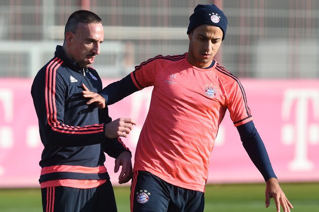 Bayern Munich's French midfielder Franck Ribery (L) and his teammate Bayern Munich's Spanish midfielder Thiago Alcantara (R) joke during a training session on the eve of the UEFA Champions League Group F football match between Bayern Munich and Dinamo Zagreb in Munich, southern Germany, on December 8, 2015. AFP PHOTO / CHRISTOF STACHE / AFP / CHRISTOF STACHE        (Photo credit should read CHRISTOF STACHE/AFP/Getty Images)