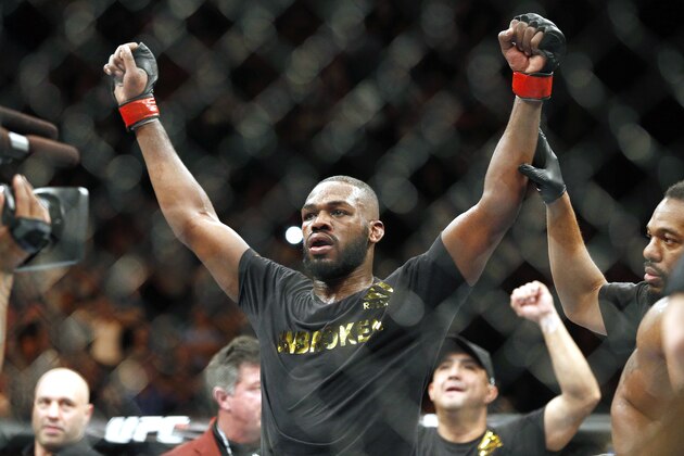 FILE - This Jan. 3, 2015, file photo shows Jon Jones celebrates after defeating Daniel Cormier during their light heavyweight title mixed martial arts bout in Las Vegas. Albuquerque police were searching for UFC light heavyweight champion Jones on Sunday night, April 26, 2015, in connection with a hit-and-run accident. Police spokesman Officer Simon Drobik said Jones is wanted for questioning about the crash, which occurred earlier in the day. No charges have been filed, but a pregnant woman driving another vehicle was hospitalized with minor injuries. (AP Photo/John Locher, File)