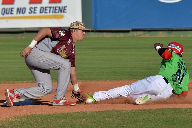Infielder Hernan Perez (L) of Venezuela makes an out on second base against Justin Greene of Mexico during during their 2016 Caribbean baseball series game on February 3, 2016 in Santo Domingo. AFP PHOTO/YAMIL LAGE / AFP / YAMIL LAGE        (Photo credit should read YAMIL LAGE/AFP/Getty Images)