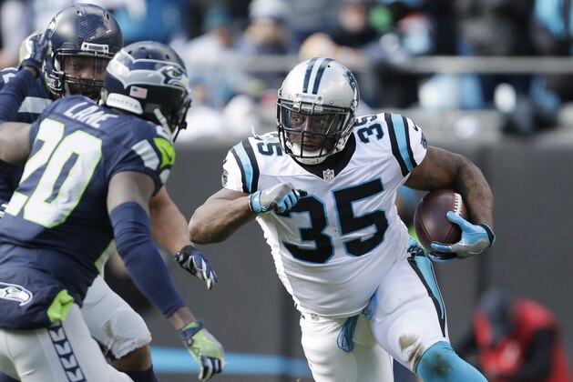 Carolina Panthers fullback Mike Tolbert (35) runs against Seattle Seahawks cornerback Jeremy Lane (20) during the first half of an NFL divisional playoff football game, Sunday, Jan. 17, 2016, in Charlotte, N.C. (AP Photo/Bob Leverone)