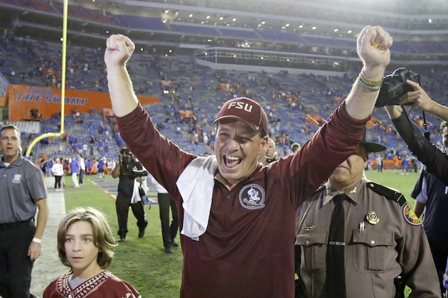 Florida State head coach Jimbo Fisher celebrates as he leaves the field with his son Ethan, left, after defeating Florida in an  NCAA college football game 27-2, Saturday, Nov. 28, 2015, in Gainesville, Fla. (AP Photo/John Raoux)