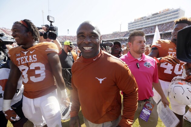 Texas running back D'Onta Foreman (33) and head coach Charlie Strong walk off the field after their NCAA college football game against Oklahoma Saturday, Oct. 10, 2015, in Dallas. (AP Photo/LM Otero)