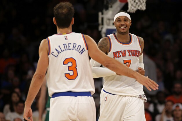 New York Knicks forward Carmelo Anthony celebrates with Jose Calderon (3) during the second half of a preseason NBA basketball game against the Boston Celtics at Madison Square Garden on Friday, Oct. 16, 2015, in New York. The Knicks defeated the Celtics 101-95. (AP Photo/Adam Hunger)
