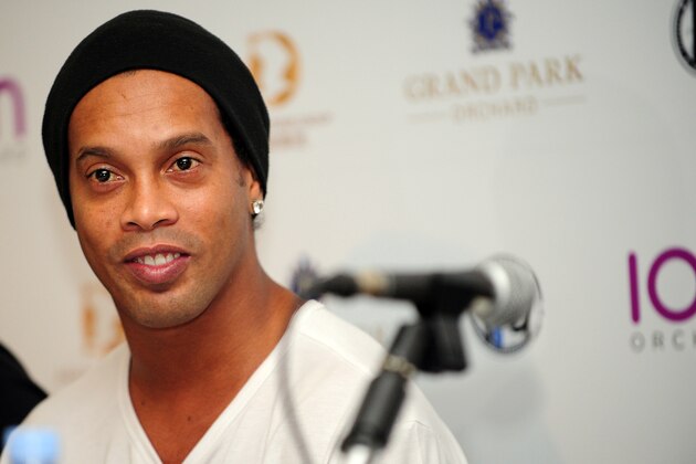 Brazil's football player Ronaldinho attends an agreement signing ceremony with local football club Tampines Rovers in Singapore on December 10, 2015. Brazilian legend Ronaldinho on December 10 signed an agreement to establish a football academy in soccer-mad Singapore, the local club that he partnered with said. AFP PHOTO / MOHD FYROL / AFP / MOHD FYROL        (Photo credit should read MOHD FYROL/AFP/Getty Images)