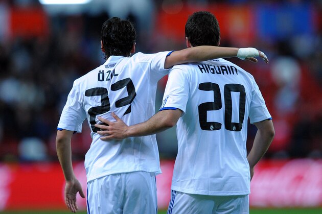 GIJON, SPAIN - NOVEMBER 14:  Gonzalo Higuain of Real Madrid celebrates with team mate Mesut Ozil after scoring a goal during the La Liga match between Sporting Gijon and Real Madrid at El Molinon Stadium on November 14, 2010 in Gijon, Spain.  (Photo by Denis Doyle/Getty Images)