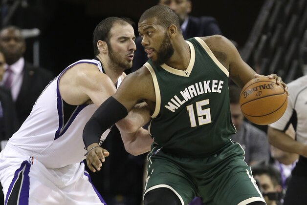 Milwaukee Bucks center Greg Monroe, right, goes to the basket against Sacramento Kings center Kosta Koufos during the second half of an NBA basketball game Monday, Feb. 1, 2016, in Sacramento, Calif. The Kings won 111-104. (AP Photo/Rich Pedroncelli)