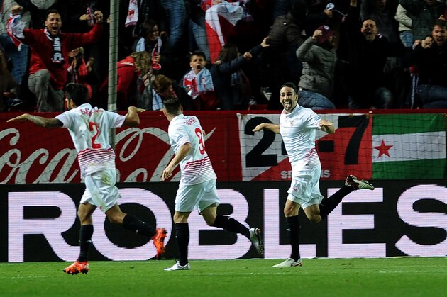 Sevilla's French defender Adil Rami (R) celebrates after scoring during the Spanish Copa del Rey (King's Cup) semifinal first leg football match Sevilla FC vs RC Celta de Vigo at the Ramon Sanchez Pizjuan stadium in Sevilla on February 4, 2016.   AFP PHOTO/ CRISTINA QUICLER / AFP / CRISTINA QUICLER        (Photo credit should read CRISTINA QUICLER/AFP/Getty Images)