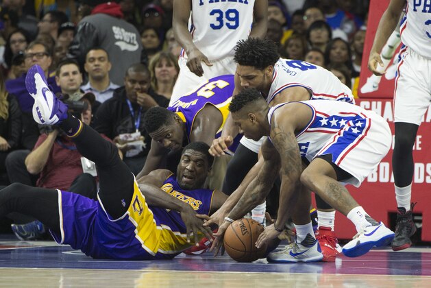PHILADELPHIA, PA - DECEMBER 1: Roy Hibbert #17 and Julius Randle #30 of the Los Angeles Lakers go after a loose ball along with Isaiah Canaan #0 and Jahlil Okafor #8 of the Philadelphia 76ers on December 1, 2015 at the Wells Fargo Center in Philadelphia, Pennsylvania. NOTE TO USER: User expressly acknowledges and agrees that, by downloading and or using this photograph, User is consenting to the terms and conditions of the Getty Images License Agreement. The 76ers defeated the Lakers 103-91. (Photo by Mitchell Leff/Getty Images)