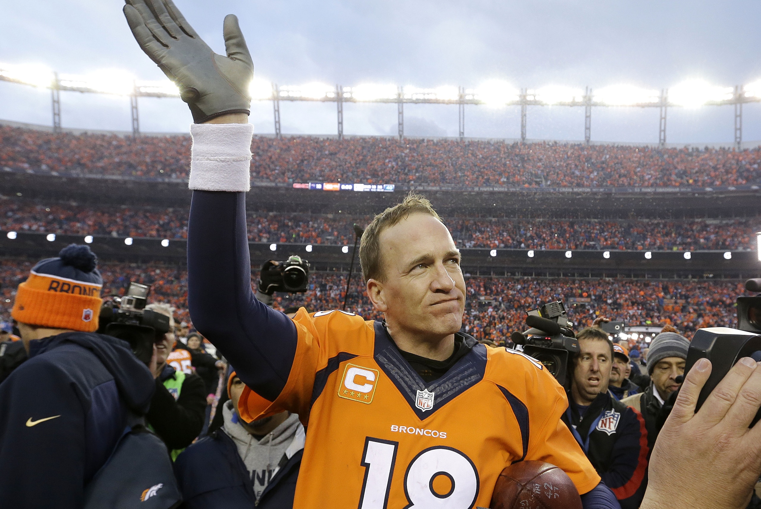 Denver Broncos quarterback Peyton Manning waves to spectators following the AFC Championship game between the Denver Broncos and the New England Patriots, Sunday, Jan. 24, 2016, in Denver. The Broncos defeated the Patriots 20-18 to advance to the Super Bowl. (AP Photo/Chris Carlson)