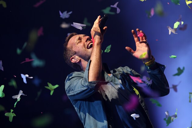 Lead singer of Coldplay Chris Martin performs on the Pyramid Stage at the Glastonbury festival near Glastonbury, Somerset on June 25, 2011. This year's festival features headline acts U2, Coldplay and Beyonce. Now in its fifth decade, the event has grown from a humble gathering of 1,500 people on Michael Eavis's Worthy dairy farm in 1970, each paying one pound and receiving free milk, to a giant five-day celebration of music costing 195 pounds for a basic ticket. AFP PHOTO / Adrian Dennis (Photo credit should read ADRIAN DENNIS/AFP/Getty Images)