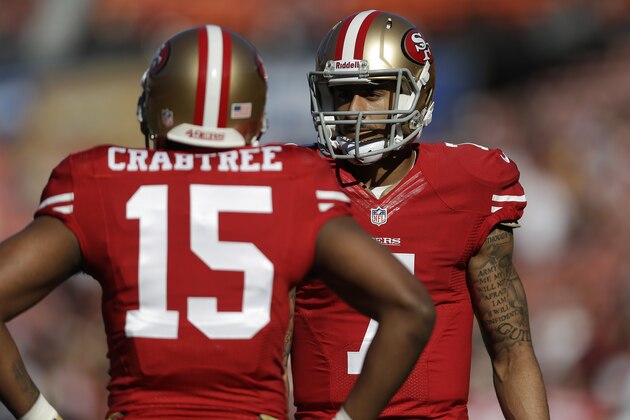 San Francisco 49ers wide receiver Michael Crabtree (15) talks with quarterback Colin Kaepernick before an NFL football game against the St. Louis Rams in San Francisco, Sunday, Dec. 1, 2013. (AP Photo/Marcio Jose Sanchez)