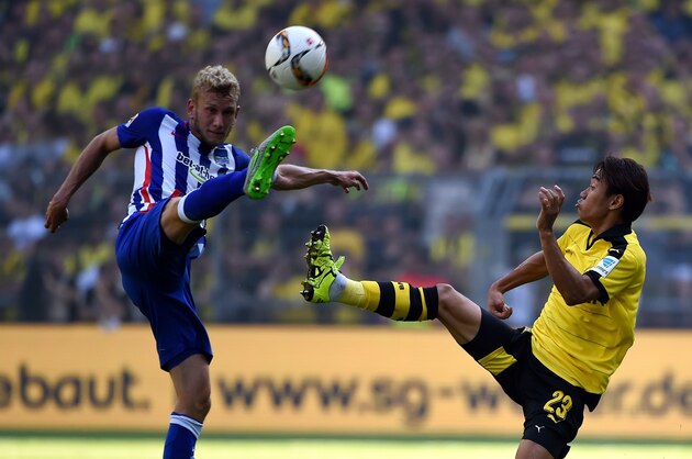 Dortmund's Greek defender Sokratis (R) and Hertha's Czech midfielder Vladimir Darida vie for the ball during the German first division Bundesliga football match Borussia Dortmund vs Hertha BSC in Dortmund, Germany, on August 30, 2015.  AFP PHOTO / PATRIK STOLLARZ RESTRICTIONS: DURING MATCH TIME: DFL RULES TO LIMIT THE ONLINE USAGE TO 15 PICTURES PER MATCH AND FORBID IMAGE SEQUENCES TO SIMULATE VIDEO.  == RESTRICTED TO EDITORIAL USE == FOR FURTHER QUERIES PLEASE CONTACT DFL DIRECTLY AT + 49 69 650050.        (Photo credit should read PATRIK STOLLARZ/AFP/Getty Images)