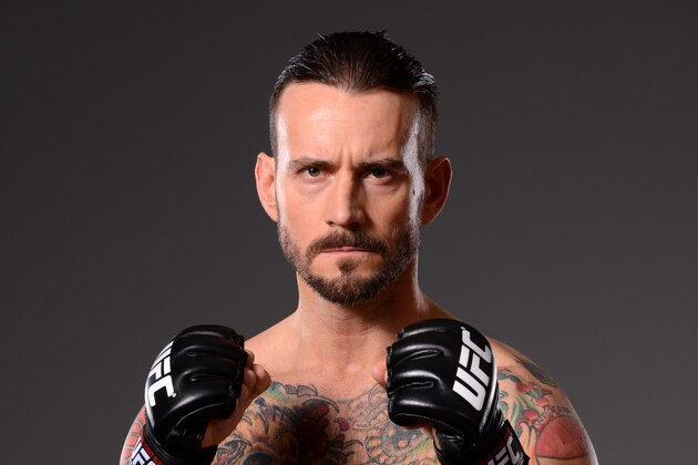 DALLAS, TX - MARCH 13:  Phil 'CM Punk' Brooks poses for a photo during a UFC photo session at the Hilton Anatole Hotel on March 13, 2015 in Dallas, Texas. (Photo by Mike Roach/Zuffa LLC/Zuffa LLC via Getty Images)