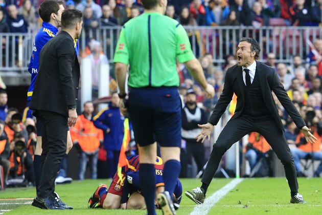 Barcelona's coach Luis Enrique (R) shouts after a fault was committed on Barcelona's Argentinian forward Lionel Messi (down) during the Spanish league football match FC Barcelona vs Club Atletico de Madrid at the Camp Nou stadium in Barcelona on January 30, 2016.   AFP PHOTO/ PAU BARRENA / AFP / PAU BARRENA        (Photo credit should read PAU BARRENA/AFP/Getty Images)