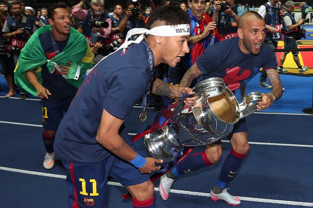 BERLIN, GERMANY - JUNE 6: Neymar (L) and Dani Alves of FC Barcelona celebrate with the trophy following the UEFA Champions League Final match between Juventus and FC Barcelona at the Olympiastadion on June 6, 2015 in Berlin, Germany. (Photo by Chris Brunskill Ltd/Getty Images)