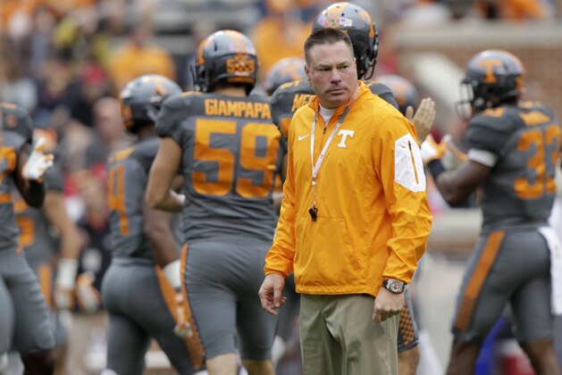 Tennessee head coach Butch Jones watches his team warm up before the start of an NCAA college football game between Tennessee and Georgia Saturday, Oct. 10, 2015 in Knoxville, Tenn. (AP Photo/Wade Payne)