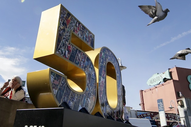 Sea gulls fly past a Super Bowl 50 sign Thursday, Feb. 4, 2016, at Fisherman's Wharf in San Francisco. (AP Photo/Charlie Riedel)