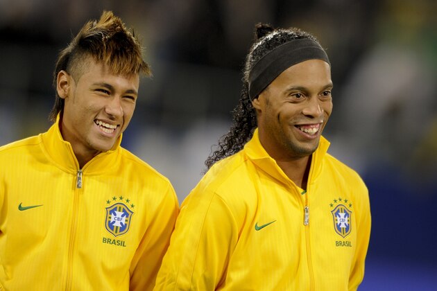 Brazil's forwards Neymar (L) and Ronaldinho smile prior to a friendly football match between Bosnia-Herzegovina and Brazil on February 28, 2012 in St-Gallen. AFP PHOTO / FABRICE COFFRINI (Photo credit should read FABRICE COFFRINI/AFP/Getty Images)