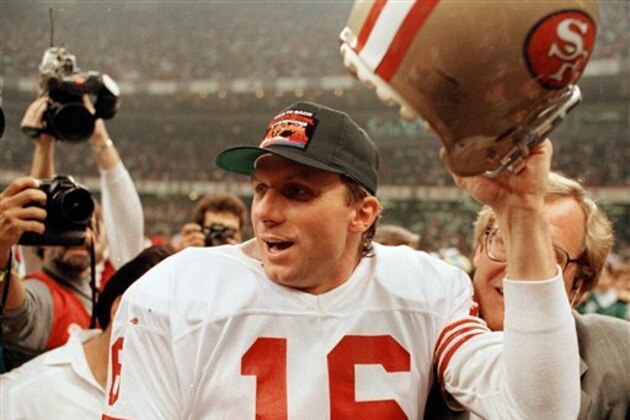FILE - In this Jan. 28, 1990, file photo, San Francisco 49ers quarterback Joe Montana raises his helmet toward the crowd as he leaves the field following the team's 55-10 victory over the Denver Broncos in Super Bowl XXIV in New Orleans. Montana won four Super Bowls, collecting three MVP trophies along the way, so it's not easy to pick his top game, but the 1990 Super Bowl might very well be it.  (AP Photo/Lennox McLennon, File)