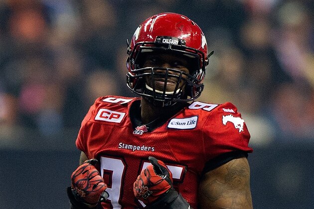 VANCOUVER, BC - NOVEMBER 30:  Freddie Bishop III #95 of the Calgary Stampeders celebrates after sacking Zach Collaros #4 of the Hamilton Tiger-Cats during the 102nd Grey Cup Championship Game at BC Place November 30, 2014 in Vancouver, British Columbia, Canada.  (Photo by Rich Lam/Getty Images)