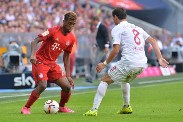 Bayern's Kingsley Coman, left, and Augsburg's Markus Feulner challenge for the ball during the German Bundesliga soccer match between FC Bayern Munich and FC Augsburg in the Allianz Arena in Munich, Germany, on Saturday, Sept. 12, 2015. (AP Photo/Kerstin Joensson)