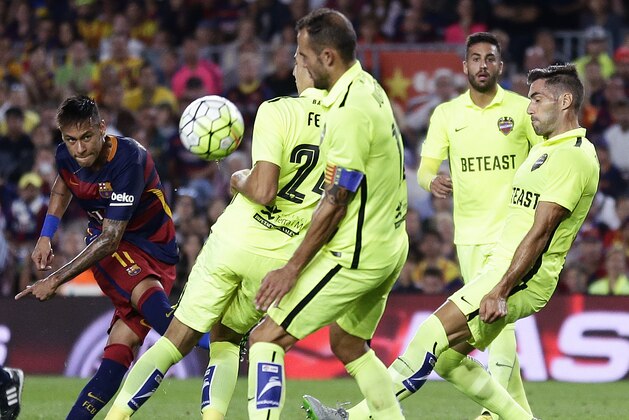 FC Barcelona's Neymar, left, kicks the ball against Levante during a Spanish La Liga soccer match at the Camp Nou stadium in Barcelona, Spain, Sunday, Sept. 20, 2015. (AP Photo/Manu Fernandez)