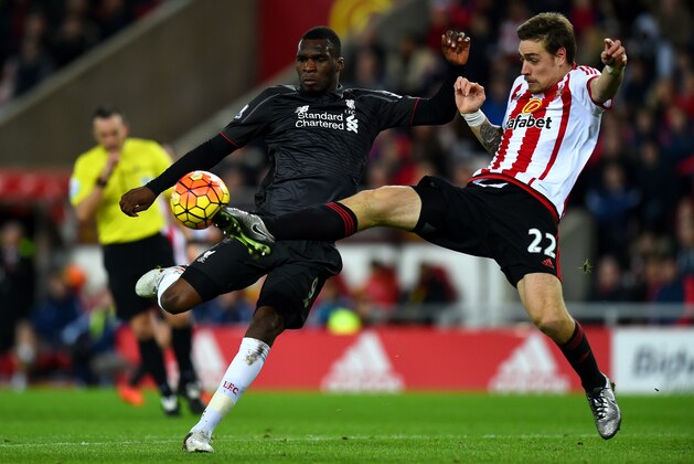 SUNDERLAND, ENGLAND - DECEMBER 30:  Christian Benteke of Liverpool attempts to shoot at goal under pressure from Sebastian Coates of Sunderland during the Barclays Premier League match between Sunderland and Liverpool at Stadium of Light on December 30, 2015 in Sunderland, England.  (Photo by Stu Forster/Getty Images)