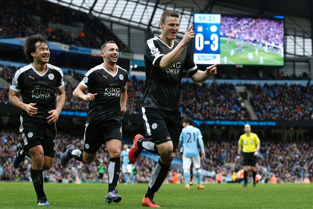 Leicester City's German defender Robert Huth (R) celebrates scoring his team's third goal with Leicester City's Japanese striker Shinji Okazaki (L) and Leicester City's Algerian midfielder Riyad Mahrez during the English Premier League football match between Manchester City and Leicester City at the Etihad Stadium in Manchester, north west England, on February 6, 2016.  / AFP / ADRIAN DENNIS / RESTRICTED TO EDITORIAL USE. No use with unauthorized audio, video, data, fixture lists, club/league logos or 'live' services. Online in-match use limited to 75 images, no video emulation. No use in betting, games or single club/league/player publications.  /         (Photo credit should read ADRIAN DENNIS/AFP/Getty Images)
