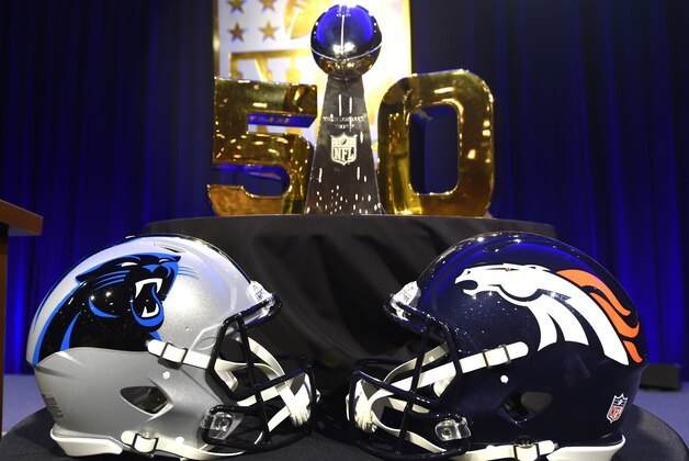 The  Vince Lombardi Trophy sits on the table along with the helmets of the Carolina Panthers and the Denver Broncos before the start of the NFL Super Bowl 50 press conference February 5, 2016 at the Moscone Convention Center in San Francisco, California.
A perfectly scripted duel between Peyton Manning and his heir apparent Cam Newton will captivate America on Sunday as the Super Bowl marks its 50th anniversary with a quarterback showdown for the ages. / AFP / Timothy A. CLARY        (Photo credit should read TIMOTHY A. CLARY/AFP/Getty Images)