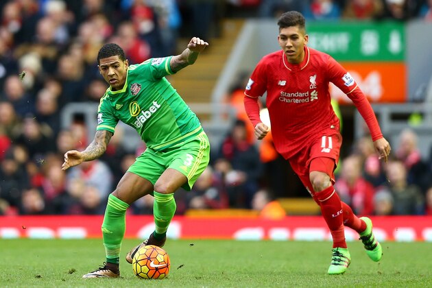 LIVERPOOL, ENGLAND - FEBRUARY 06: Patrick van Aanholt of Sunderland and Roberto Firmino of Liverpool compete for the ball during the Barclays Premier League match between Liverpool and Sunderland at Anfield on February 6, 2016 in Liverpool, England.  (Photo by Clive Brunskill/Getty Images)